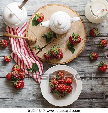 Strawberries and cream on wooden table View Large Photo Image Stock Photo - Strawberries and cream on wooden table. Fotosearch