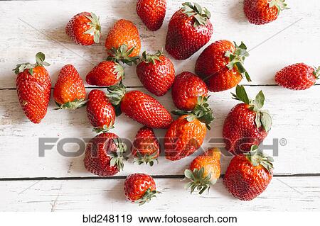 Stock Photo - Strawberries on the wooden table. Fotosearch
