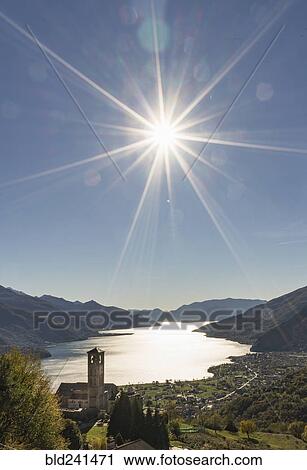 Sun in blue sky over Gravedona, Lake Como, Italy View Large Photo Image Stock Image - Sun in blue sky over Gravedona, Lake Como, Italy. Fotosearch