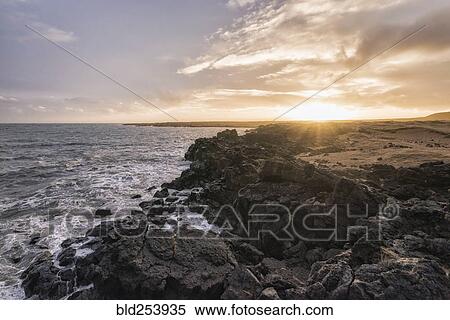 Sunset on rocky ocean beach View Large Photo Image Stock Photography - Sunset on rocky ocean beach. Fotosearch