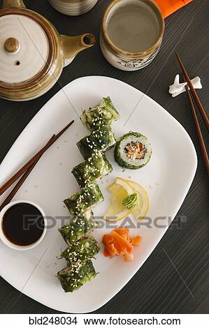 Picture - Sushi on plate with lemon and ginger. Fotosearch