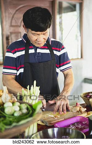 Thai man chopping food on cutting board View Large Photo Image Stock Image - Thai man chopping food on cutting board. Fotosearch