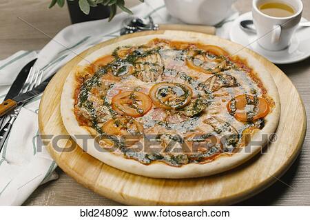 Tomatoes and pesto sauce on pizza View Large Photo Image Stock Image - Tomatoes and pesto sauce on pizza. Fotosearch