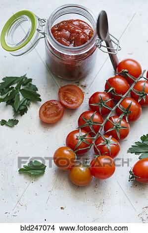 Tomatoes on vine near jar View Large Photo Image Picture - Tomatoes on vine near jar. Fotosearch