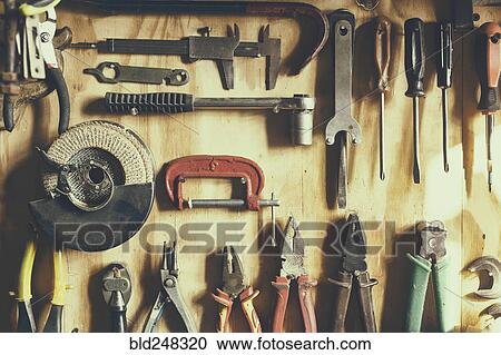 Tools hanging on wooden wall View Large Photo Image Stock Image - Tools hanging on wooden wall. Fotosearch