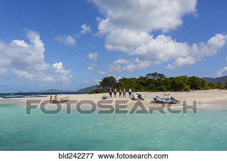 Stock Photo - Tourists standing on tropical beach. Fotosearch