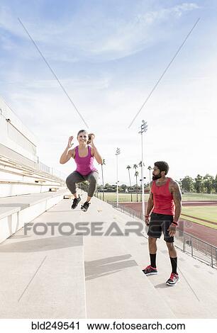 Trainer watching woman jumping on bleachers View Large Photo Image Stock Image - Trainer watching woman jumping on bleachers. Fotosearch