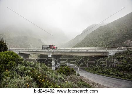 Truck driving on overpass in hills View Large Photo Image Stock Image - Truck driving on overpass in hills. Fotosearch