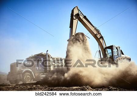 Truck near digger in dirt field View Large Photo Image Picture - Truck near digger in dirt field. Fotosearch
