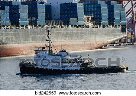 Tugboat in harbor at shipping port View Large Photo Image Stock Photo - Tugboat in harbor at shipping port. Fotosearch