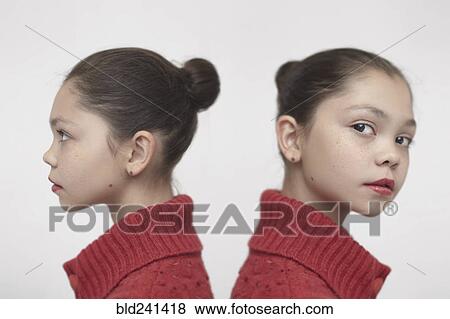 Stock Photo - Twin Caucasian girls wearing red sweater. Fotosearch
