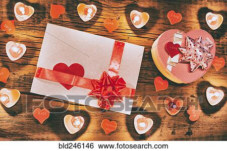 Valentine candles burning on table with gift box and card View Large Photo Image Stock Photograph - Valentine candles burning on table with gift box and card. Fotosearch