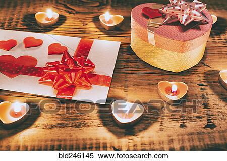 Valentine candles burning on table with gift box and card View Large Photo Image Stock Photography - Valentine candles burning on table with gift box and card. Fotosearch