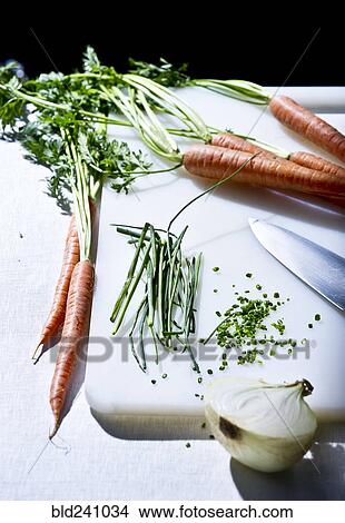 Picture - Vegetables and knife on cutting board. Fotosearch