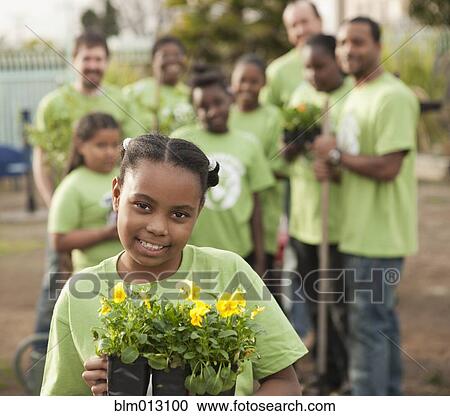 Volunteers planting flowers in playground View Large Photo Image Stock Image - Volunteers planting flowers in playground. Fotosearch