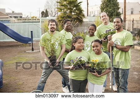 Stock Photo - Volunteers planting flowers in playground. Fotosearch