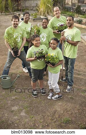 Stock Photo - Volunteers planting flowers in playground. Fotosearch