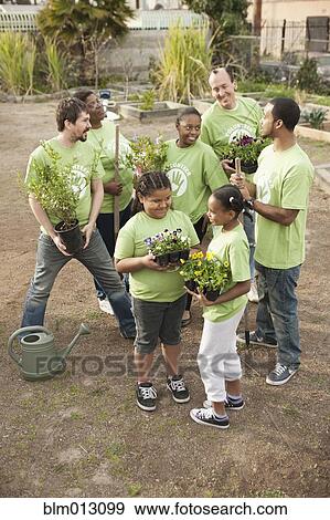 Stock Photo - Volunteers planting flowers in playground. Fotosearch