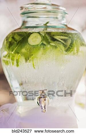 Water beading on vase of water with fresh cucumbers View Large Photo Image Stock Photo - Water beading on vase of water with fresh cucumbers. Fotosearch