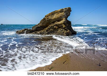 Waves splashing on rock at ocean beach View Large Photo Image Stock Image - Waves splashing on rock at ocean beach. Fotosearch