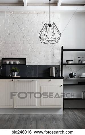 Stock Photograph - White and black domestic kitchen. Fotosearch