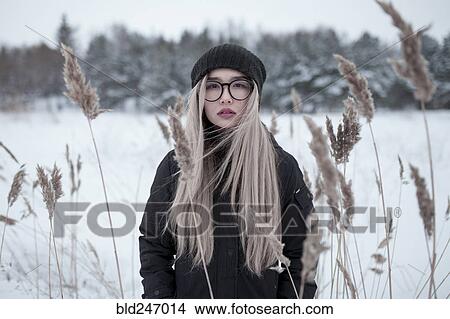 Picture - Wind blowing hair of Asian woman in winter. Fotosearch