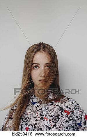 Stock Photograph - Wind blowing hair of Caucasian teenage girl. Fotosearch