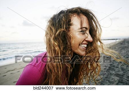 Wind blowing hair of Caucasian woman on beach View Large Photo Image Stock Photo - Wind blowing hair of Caucasian woman on beach. Fotosearch