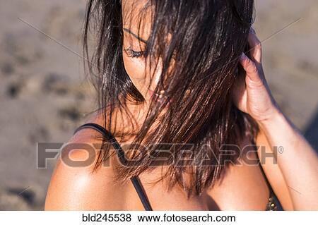 Wind blowing hair of Caucasian woman on beach View Large Photo Image Stock Photo - Wind blowing hair of Caucasian woman on beach. Fotosearch