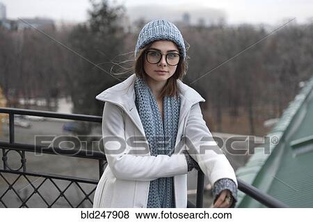 Stock Photo - Wind blowing hair of Caucasian woman wearing hat and scarf. Fotosearch