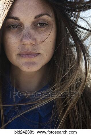 Wind blowing hair of Caucasian woman with freckles View Large Photo Image Stock Photography - Wind blowing hair of Caucasian woman with freckles. Fotosearch