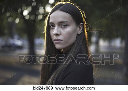 Stock Photo - Wind blowing hair of serious Caucasian woman. Fotosearch