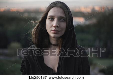 Stock Photo - Wind blowing hair of serious Caucasian woman. Fotosearch