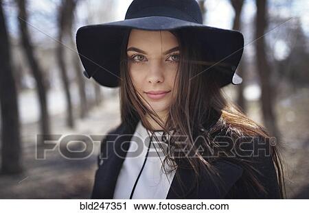 Wind blowing hair of woman wearing hat View Large Photo Image Stock Image - Wind blowing hair of woman wearing hat. Fotosearch