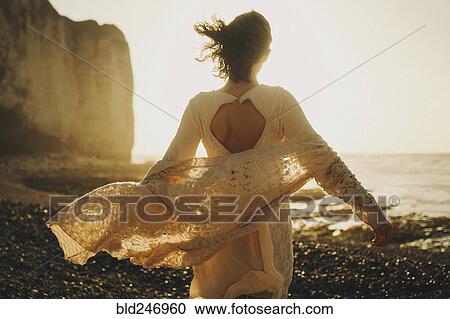 Wind blowing sweater of Caucasian woman at beach View Large Photo Image Stock Image - Wind blowing sweater of Caucasian woman at beach. Fotosearch