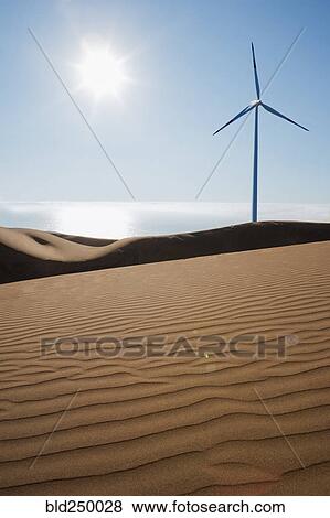 Stock Photo - Wind turbine on sunny beach. Fotosearch