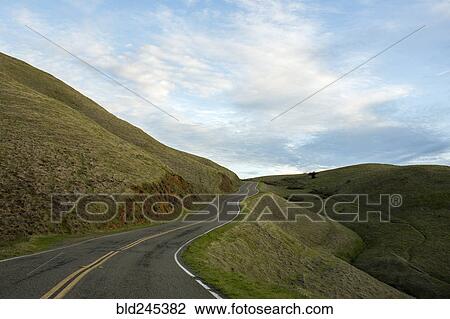 Stock Image - Winding road on hill. Fotosearch