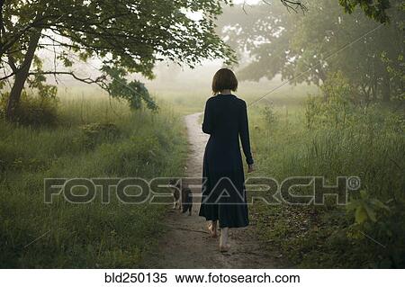 Woman and cat walking on path in fog View Large Photo Image Stock Photography - Woman and cat walking on path in fog. Fotosearch