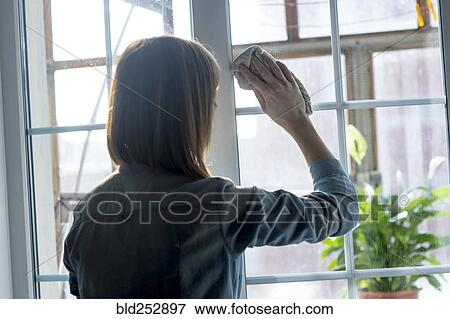 Woman cleaning window with rag View Large Photo Image Stock Photo - Woman cleaning window with rag. Fotosearch