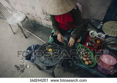 Woman cooking egg on grille View Large Photo Image Stock Image - Woman cooking egg on grille. Fotosearch