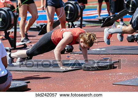 Stock Photo - Woman doing push-ups outdoors. Fotosearch