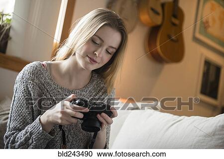 Woman examining camera View Large Photo Image Stock Image - Woman examining camera. Fotosearch