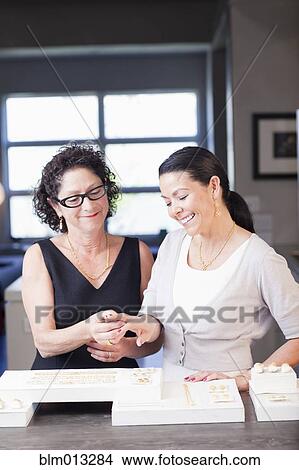 Picture - Woman helping customer in jewelry store. Fotosearch