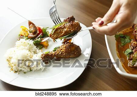 Woman holding meat over plate with fork and spoon View Large Photo Image Stock Photography - Woman holding meat over plate with fork and spoon. Fotosearch