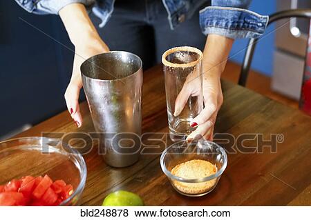 Stock Photo - Woman preparing cocktail. Fotosearch