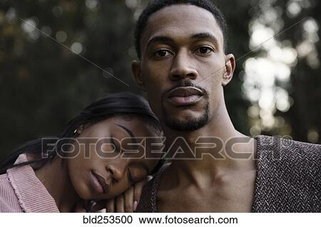 Stock Image - Woman resting head on shoulder of man. Fotosearch