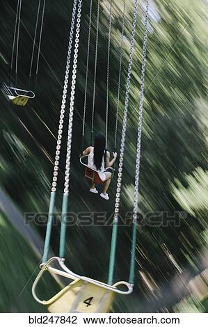 Woman riding amusement park swing View Large Photo Image Stock Image - Woman riding amusement park swing. Fotosearch