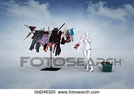Woman robot hanging laundry on clothesline View Large Photo Image Stock Image - Woman robot hanging laundry on clothesline. Fotosearch