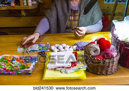 Woman sewing fabric reaching for scissors at table View Large Photo Image Stock Image - Woman sewing fabric reaching for scissors at table. Fotosearch