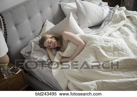 Woman sleeping in bed View Large Photo Image Stock Photography - Woman sleeping in bed. Fotosearch